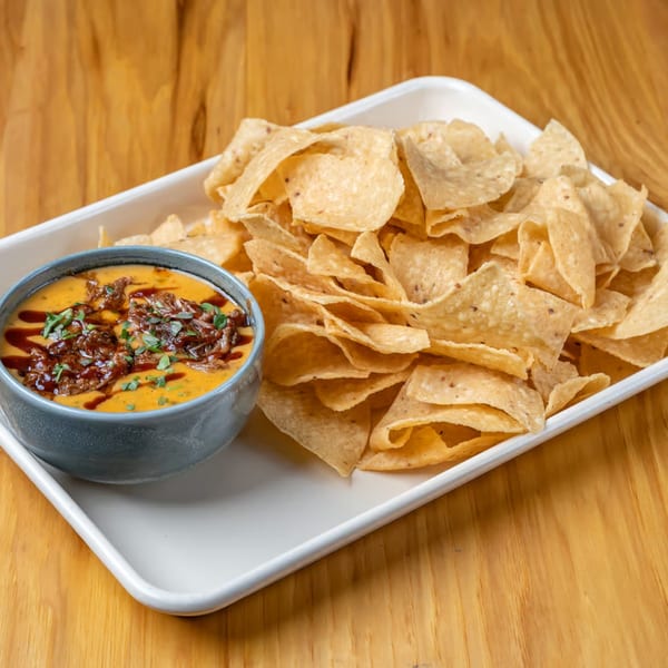 LSA Burger Co.'s queso with brisket and cilantro, served with a large tray of tortilla chips.